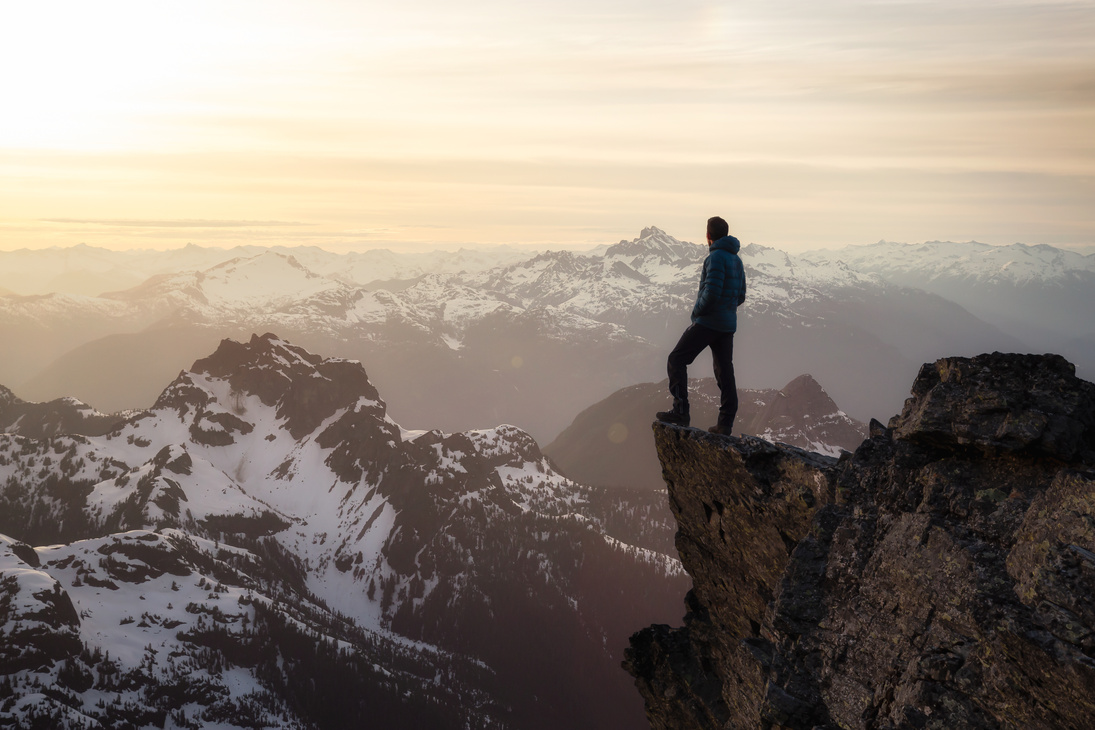 Person on Top of a Mountain Cliff